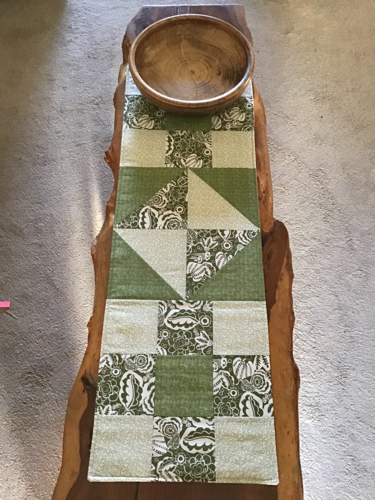 Patchwork table runner with wooden bowl